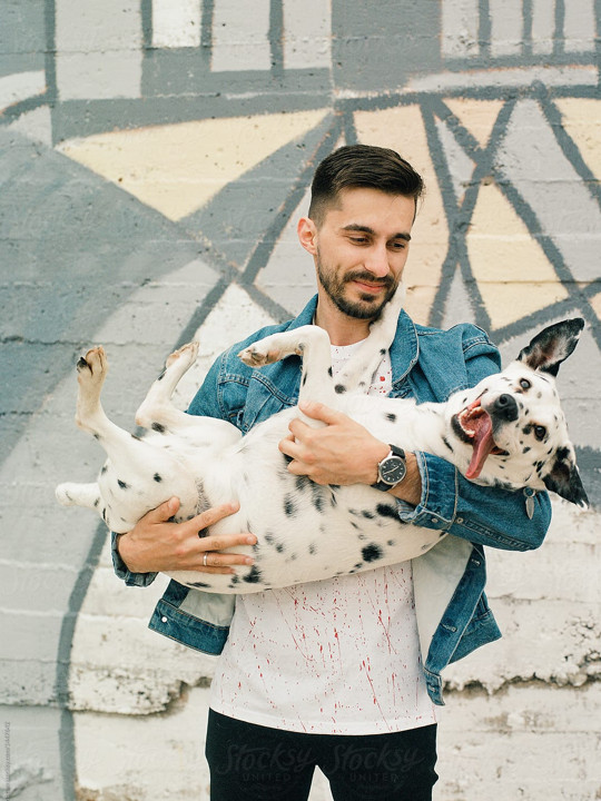 Guy Holding Funny Dog In His Arms